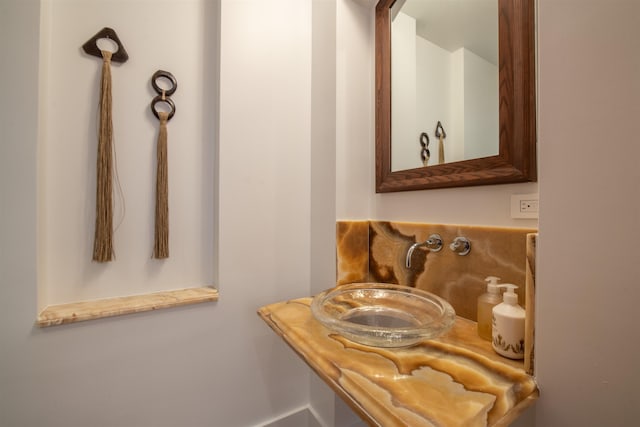 bathroom featuring backsplash and sink