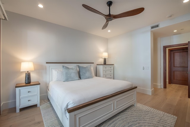 bedroom with ceiling fan and light hardwood / wood-style flooring