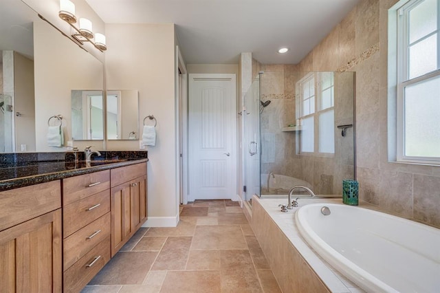 bathroom featuring separate shower and tub and vanity