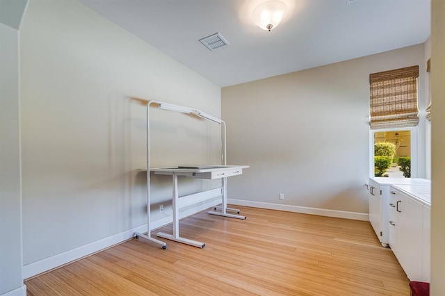 unfurnished office featuring light hardwood / wood-style floors