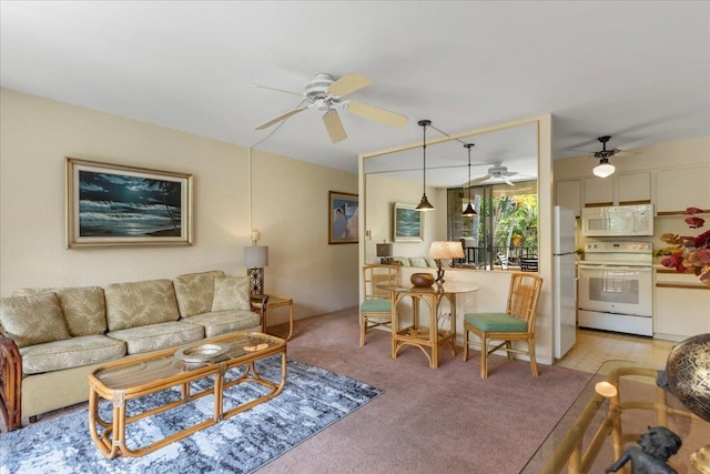 carpeted living room featuring ceiling fan