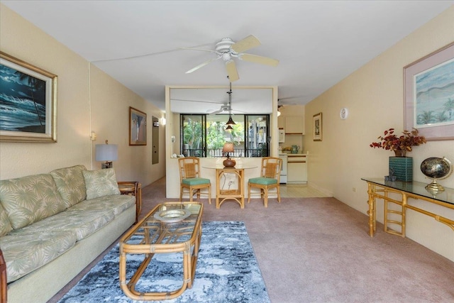 carpeted living room featuring ceiling fan