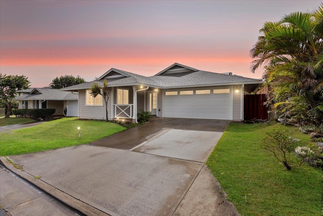 view of front of home featuring a garage and a yard