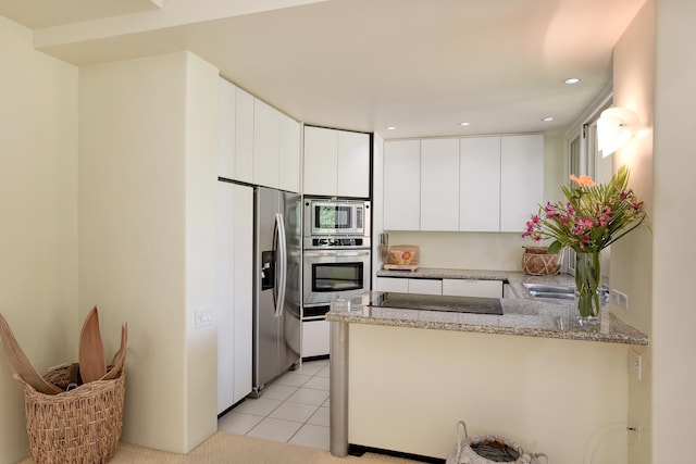 3150 Wailea Alanui Dr Unit 3807, Kihei, HI 96753 - kitchen featuring light stone counters, a peninsula, white cabinets, and stainless steel appliances