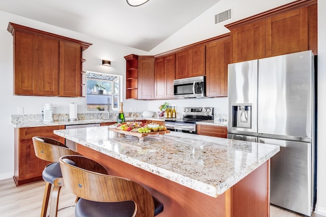 9 Fern Pl, Lahaina, HI 96761 - kitchen with open shelves, light wood-style floors, a center island, stainless steel appliances, and vaulted ceiling
