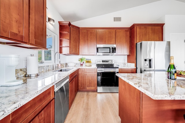 9 Fern Pl, Lahaina, HI 96761 - kitchen featuring lofted ceiling, light wood-style floors, light stone counters, a sink, and appliances with stainless steel finishes