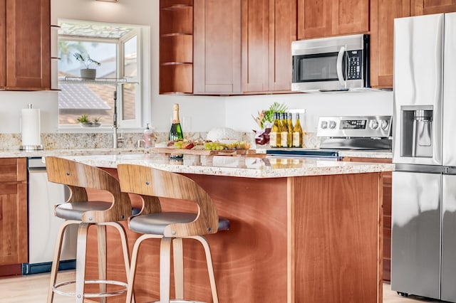 9 Fern Pl, Lahaina, HI 96761 - kitchen with a kitchen breakfast bar, appliances with stainless steel finishes, open shelves, light stone countertops, and a sink