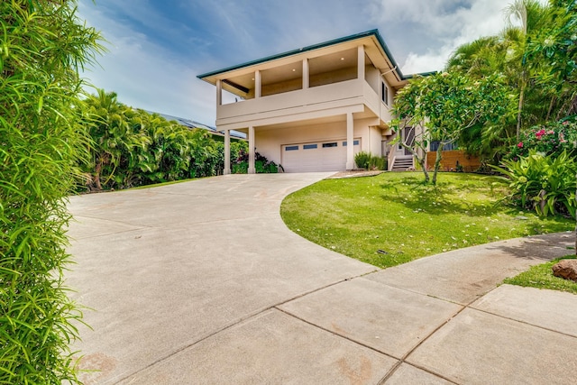 9 Fern Pl, Lahaina, HI 96761 - view of front facade with an attached garage, stucco siding, a front yard, and concrete driveway