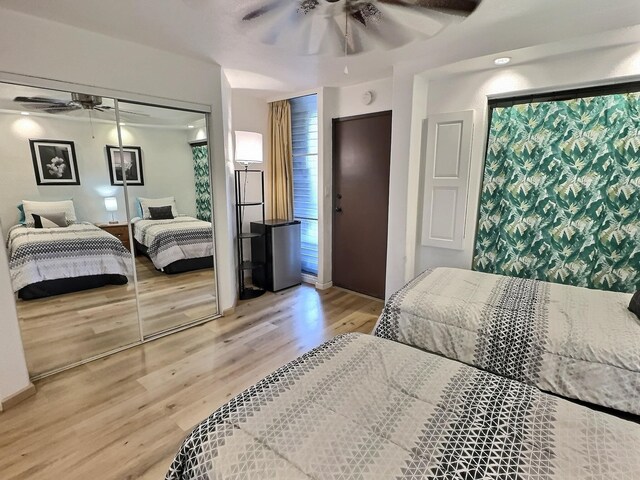 bedroom featuring light hardwood / wood-style floors, a closet, and ceiling fan