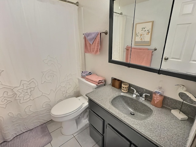 bathroom featuring toilet, large vanity, and tile floors