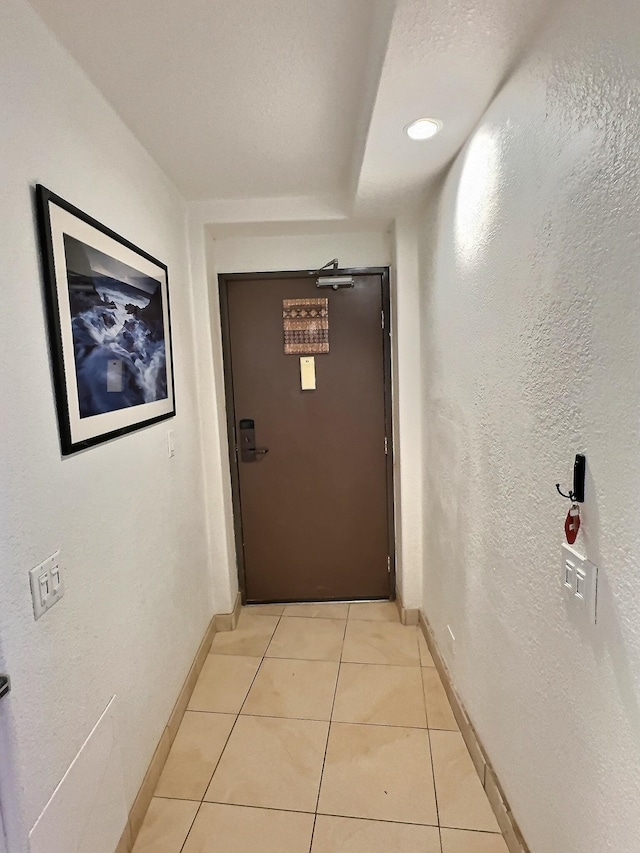 corridor featuring light tile flooring