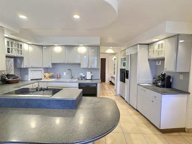 kitchen featuring white cabinetry, light hardwood / wood-style flooring, sink, and black appliances