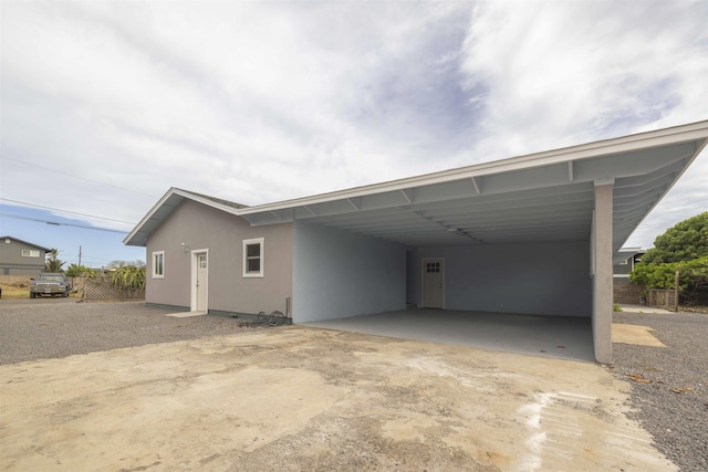 585 Linekona Pl, Wailuku, HI 96793 - rear view of property with an attached carport, stucco siding, and concrete driveway