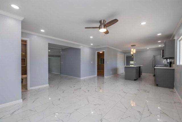 unfurnished living room with sink, crown molding, and ceiling fan