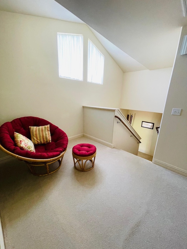 living area with carpet and lofted ceiling