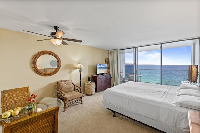 bedroom with access to exterior, ceiling fan, expansive windows, and light carpet