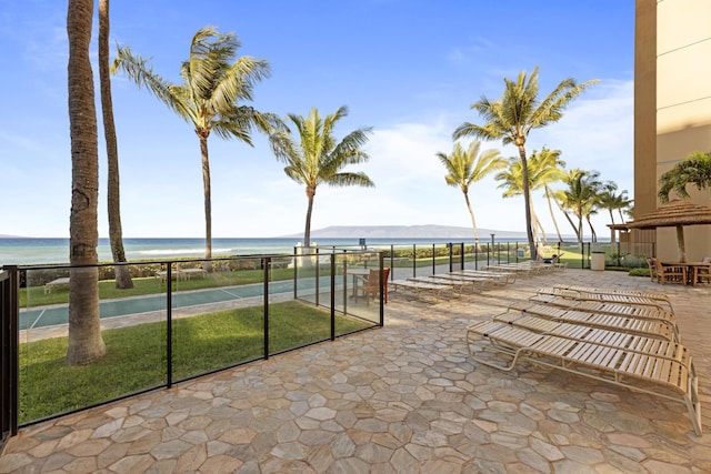 view of patio / terrace featuring a water and mountain view