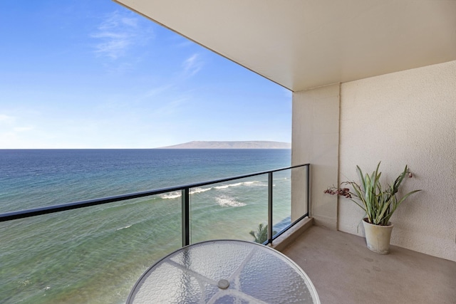 balcony featuring a water and mountain view