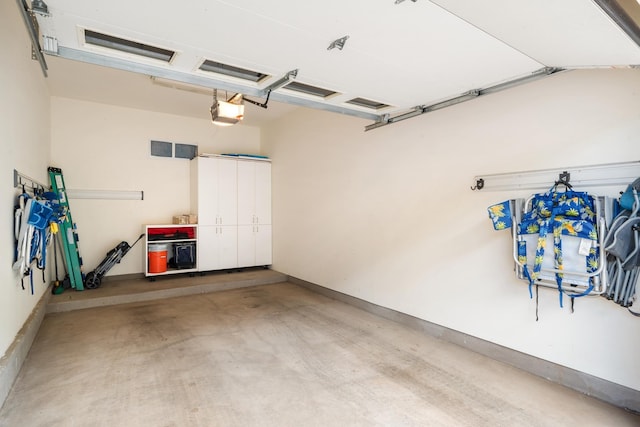 161 Wailea Ike Pl Unit D201, Kihei, HI 96753 - garage featuring a garage door opener and baseboards