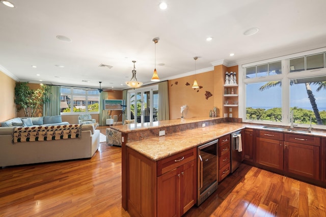 161 Wailea Ike Pl Unit D201, Kihei, HI 96753 - kitchen with a sink, beverage cooler, open floor plan, ornamental molding, and a peninsula