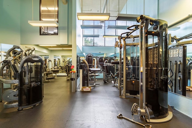 gym with a towering ceiling