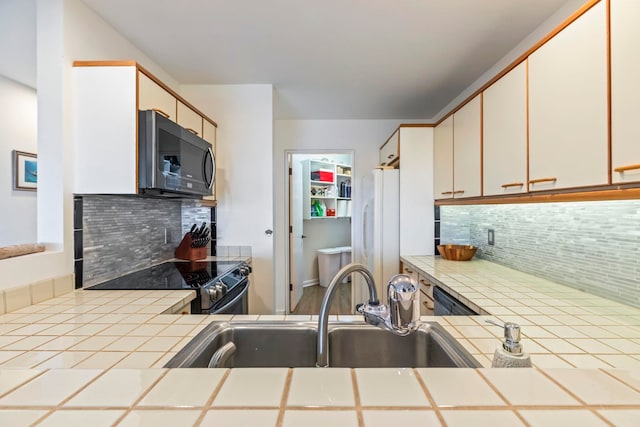 50 Puu Anoano St Unit 503, Lahaina, HI 96761 - kitchen featuring a sink, tasteful backsplash, tile counters, freestanding refrigerator, and black / electric stove