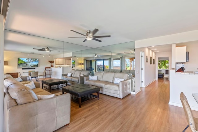 50 Puu Anoano St Unit 503, Lahaina, HI 96761 - living room featuring light wood-style floors, ceiling fan, and baseboards