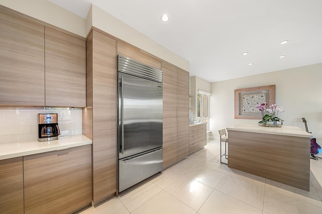 kitchen with light tile patterned flooring and stainless steel built in refrigerator