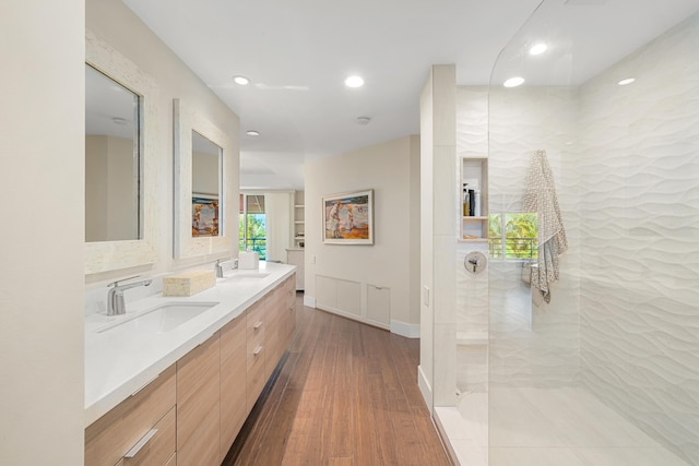 bathroom with vanity, hardwood / wood-style floors, and a tile shower