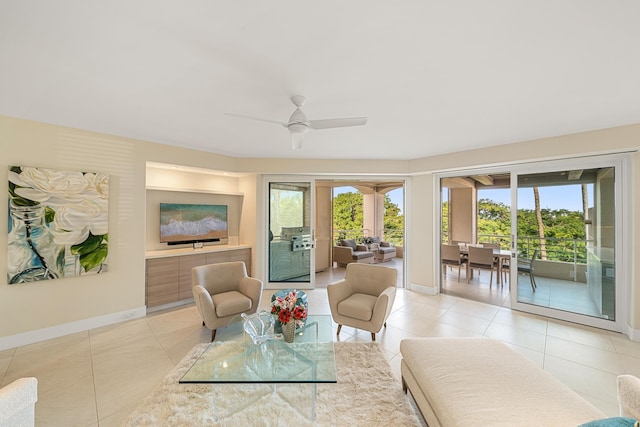 living room featuring light tile patterned floors and ceiling fan