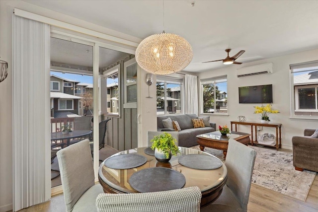 sunroom / solarium with a healthy amount of sunlight, ceiling fan with notable chandelier, and a wall unit AC