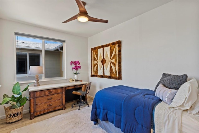 bedroom with ceiling fan and light hardwood / wood-style floors