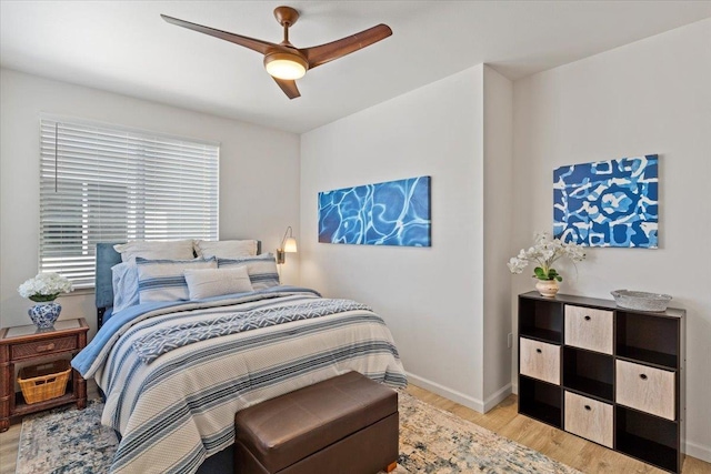 bedroom with light hardwood / wood-style flooring and ceiling fan