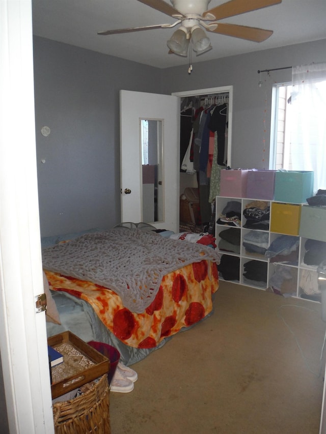 bedroom with carpet floors, a closet, and a ceiling fan