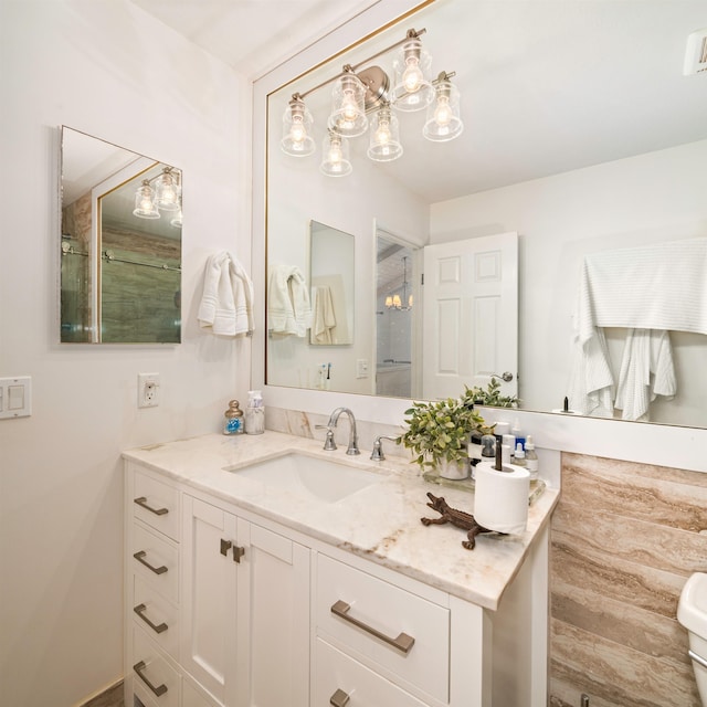 bathroom with an enclosed shower and vanity