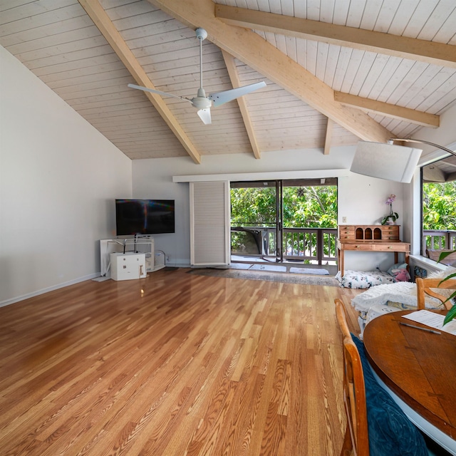 unfurnished living room with lofted ceiling with beams, hardwood / wood-style floors, and ceiling fan