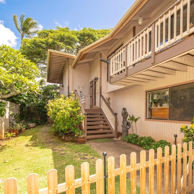 exterior space with a balcony and a front lawn