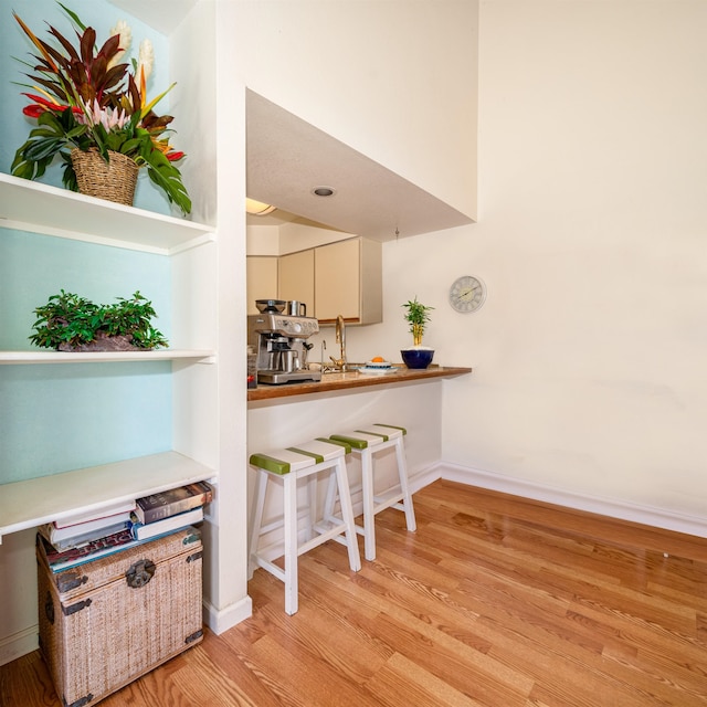 kitchen with light hardwood / wood-style flooring and cream cabinetry