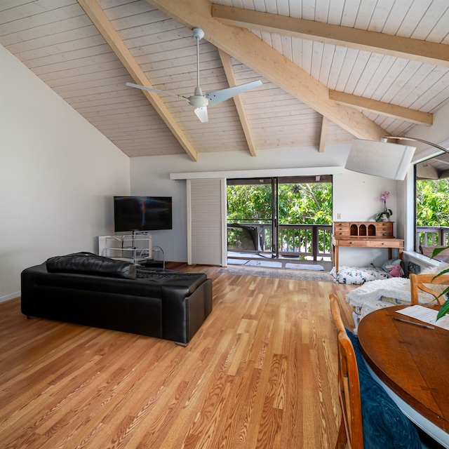 living room featuring light wood-type flooring, vaulted ceiling with beams, and ceiling fan