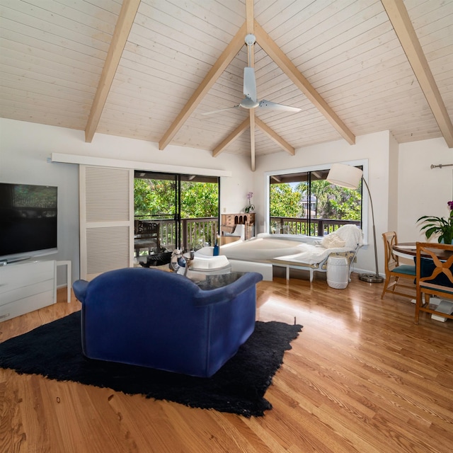 living room with lofted ceiling with beams, wood-type flooring, and ceiling fan