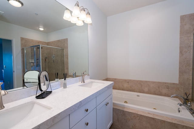 bathroom featuring an inviting chandelier, vanity, and shower with separate bathtub