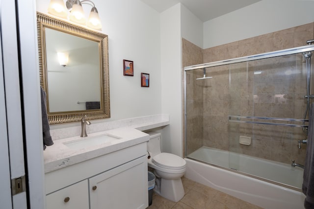 full bathroom with vanity, tile patterned floors, combined bath / shower with glass door, and toilet