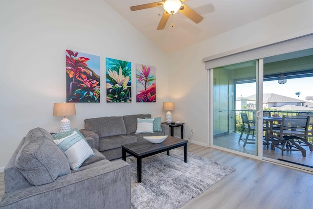 living room featuring lofted ceiling, hardwood / wood-style floors, and ceiling fan