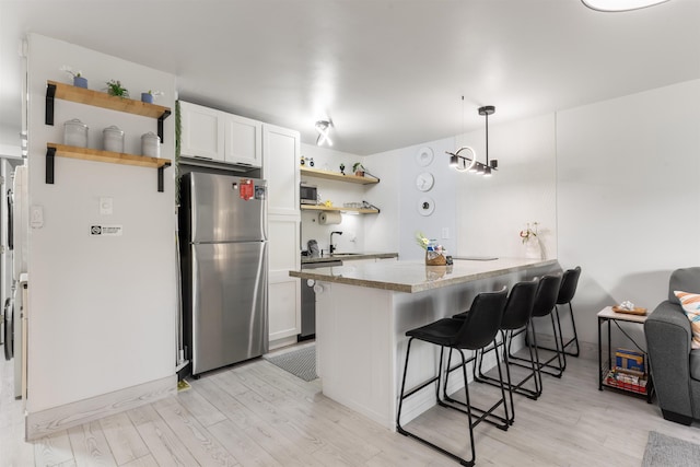 3559 Lower Honoapiilani Rd Unit 709, Lahaina, HI 96761 - kitchen featuring open shelves, stainless steel appliances, and light wood-style flooring
