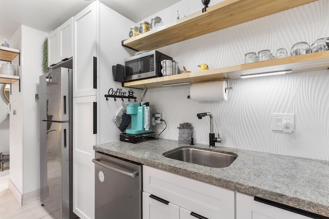 3559 Lower Honoapiilani Rd Unit 709, Lahaina, HI 96761 - kitchen featuring light stone counters, open shelves, a sink, stainless steel appliances, and white cabinetry