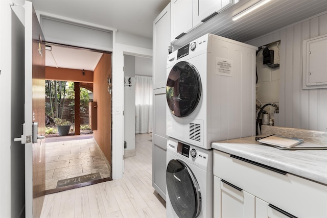 3559 Lower Honoapiilani Rd Unit 709, Lahaina, HI 96761 - washroom with cabinet space, stacked washer and clothes dryer, and light wood-type flooring