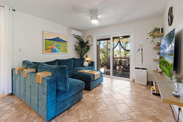 living room featuring a textured ceiling, an AC wall unit, and ceiling fan