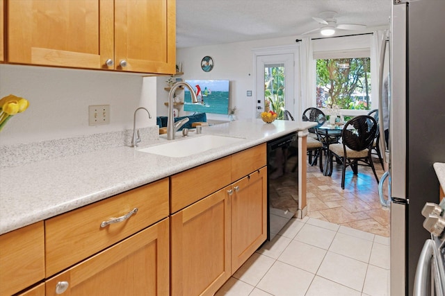 kitchen featuring dishwasher, sink, ceiling fan, a textured ceiling, and stainless steel refrigerator