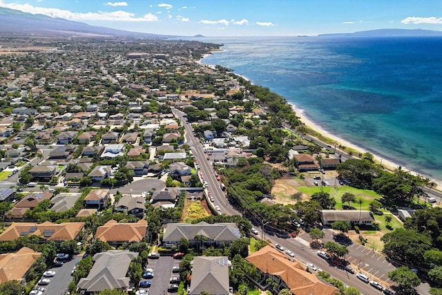 drone / aerial view with a beach view and a water and mountain view