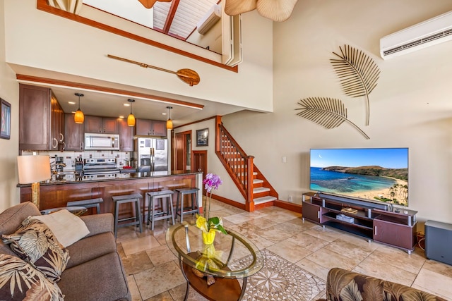 living room featuring a high ceiling and a wall mounted air conditioner